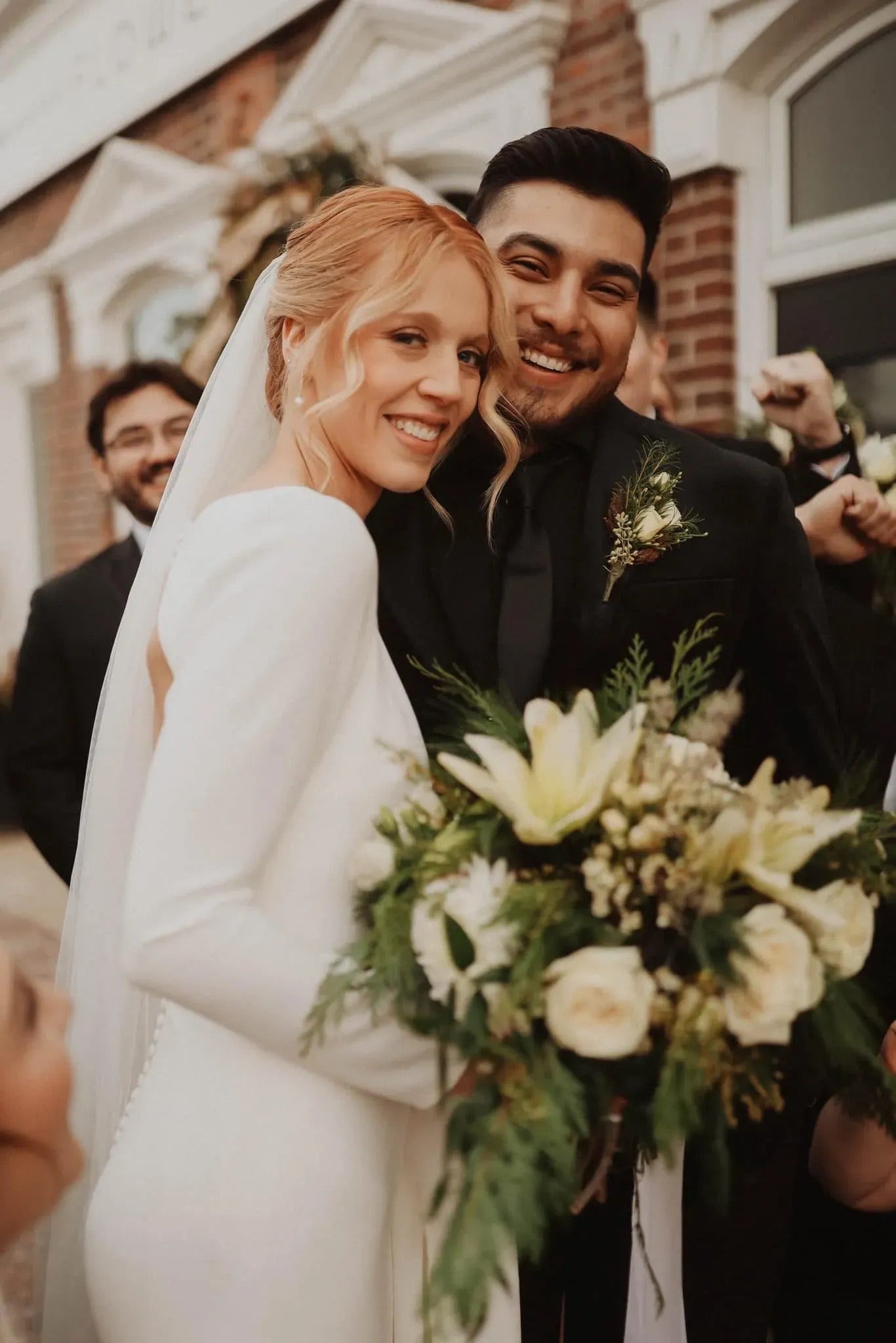 Bride and groom with white and green winter wedding bouquet, Pella, Iowa