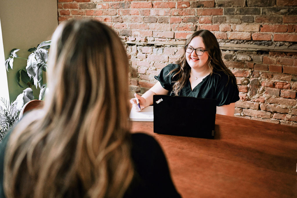 Wedding coordination services, a woman meeting with a bride in Pella Iowa at Thistles Flower Market