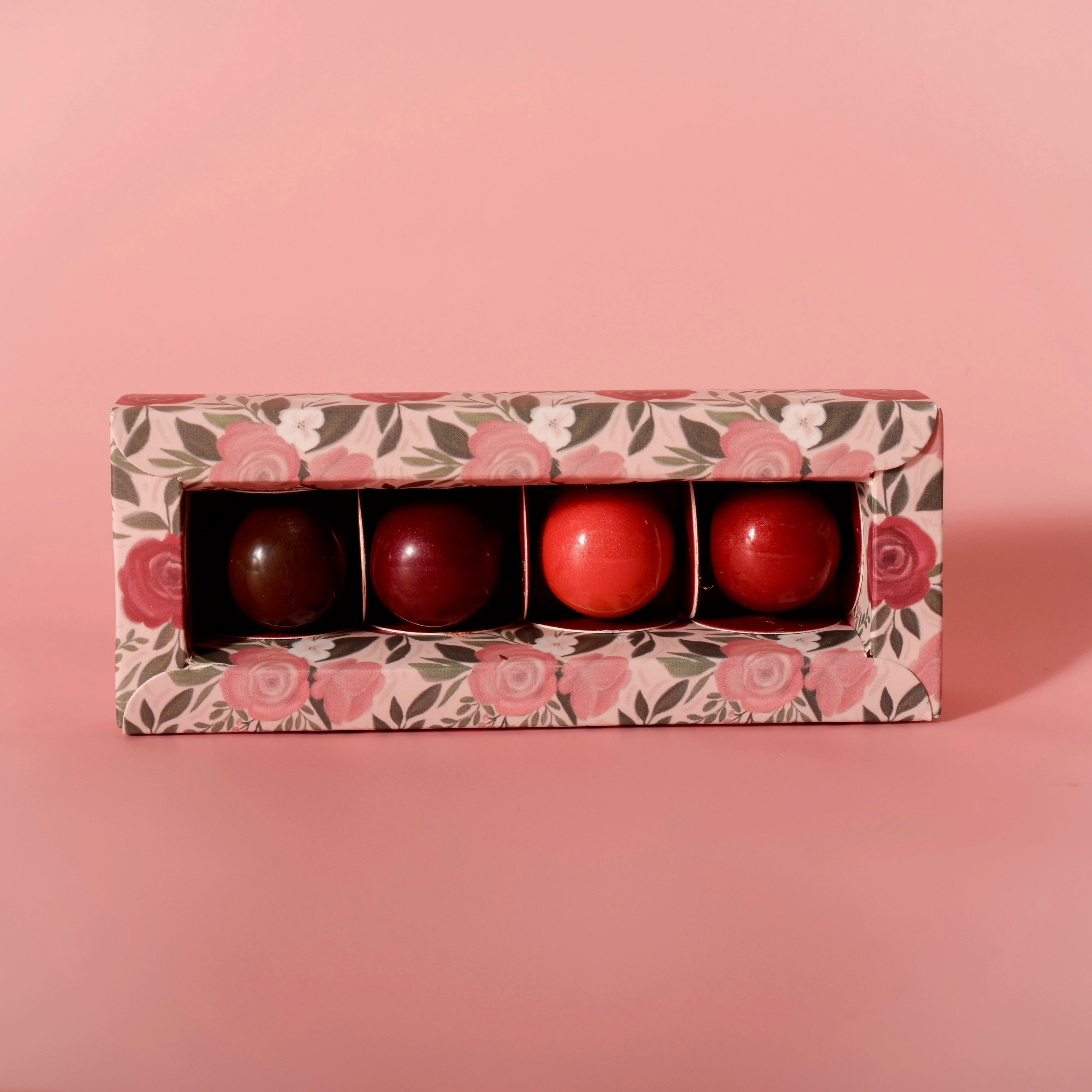 Four artisan chocolate truffles from Garden Square Chocolatier, handmade at Thistles Flower Market, arranged in a gift box