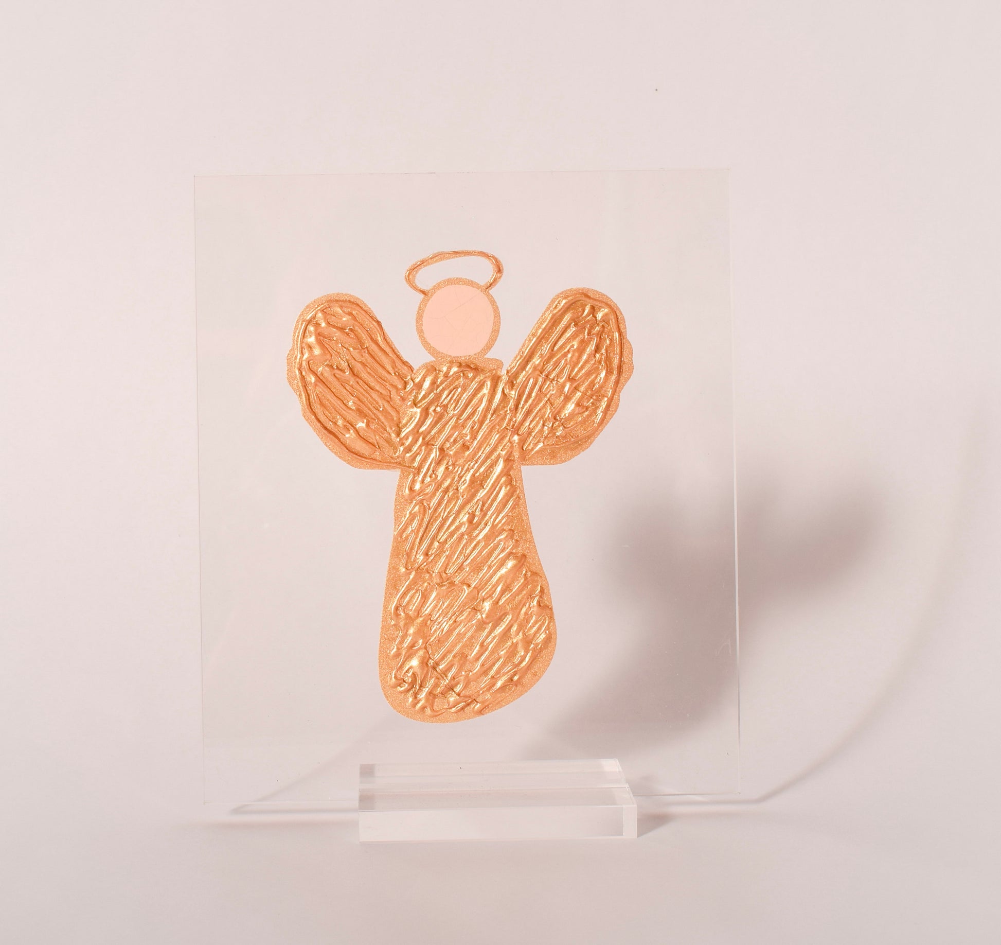Gold angel acrylic plaque displayed in a clear acrylic stand, sold at Thistles in Pella, Iowa