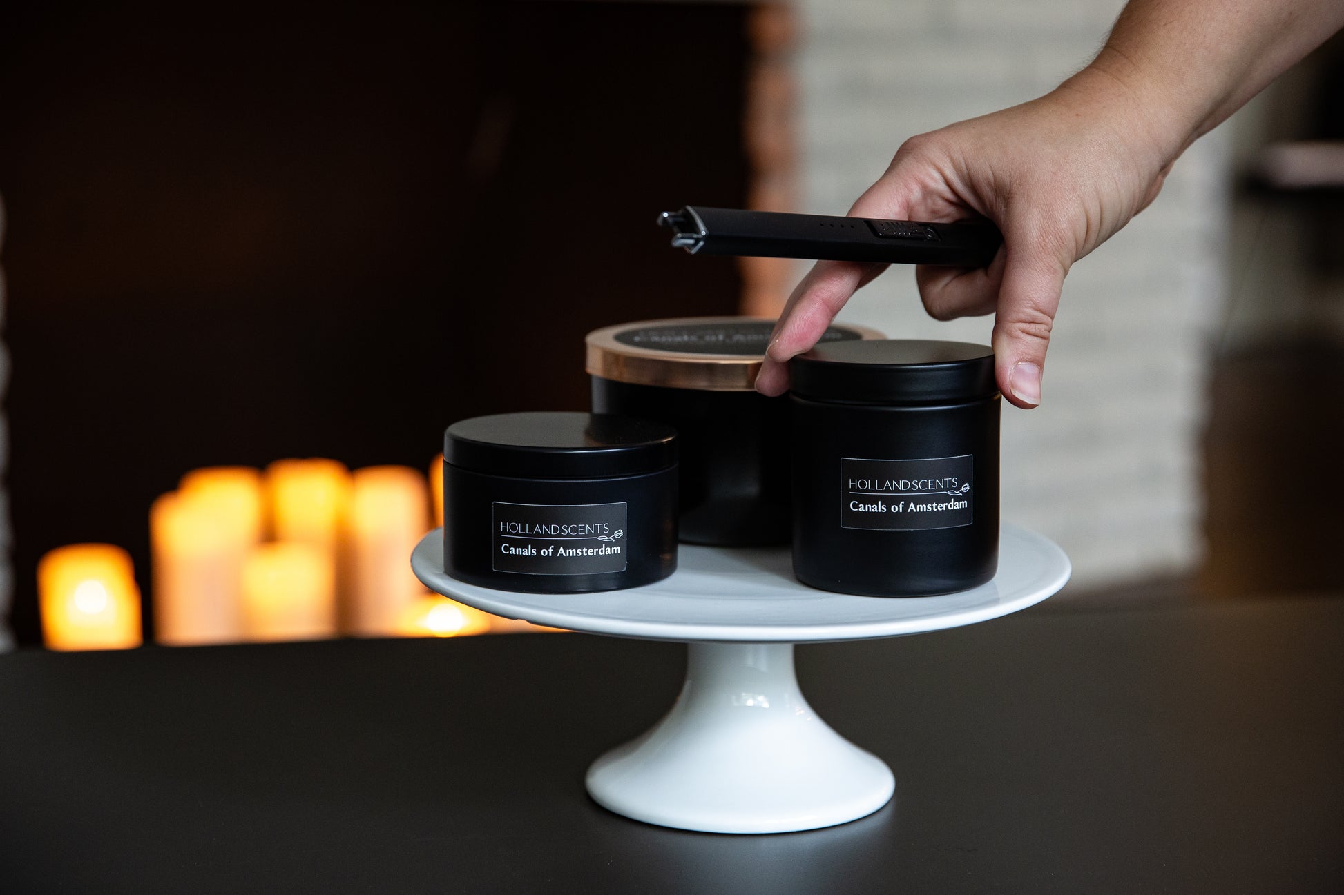 Holland Scents Canals of Amsterdam soy candle in three sizes displayed on a cake stand, Pella, Iowa