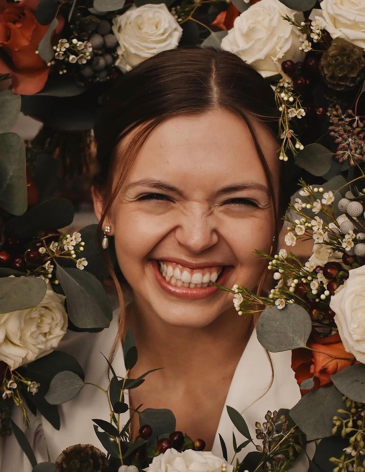 Bride smiling with fall wedding floral bouquet, Pella, Iowa