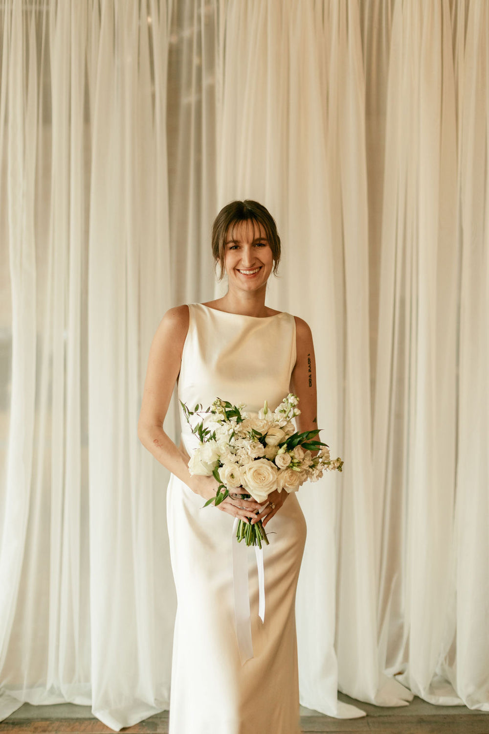 White bridal bouquet made by Thistles Flower Market for a wedding at Tamory in Pella, Iowa