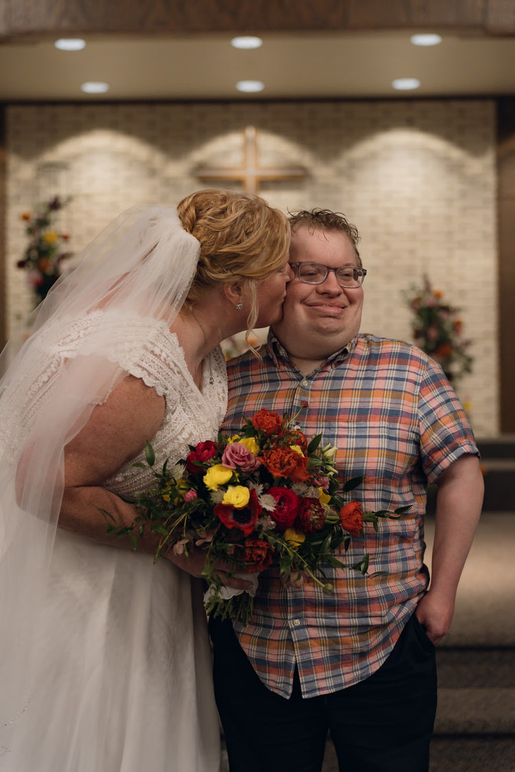 Bride holding a bright, colorful floral bouquet, Pella, Iowa